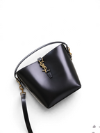 SWORD LUXURY siyah box dana derisi Le 37 küçük kova çanta, fırçalanmış altın tonlu YSL monogram detaylı.