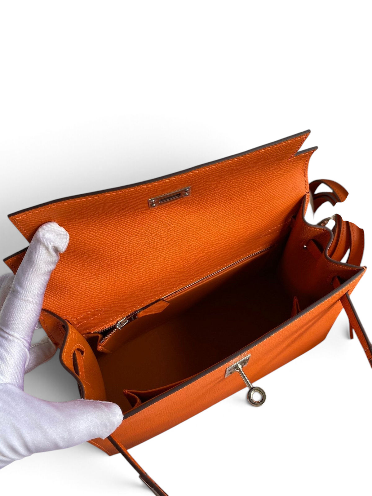 SWORD LUXURY turuncu Epsom deri Kelly 25 çanta, gümüş donanımlı iç bölmeleri ve kutu içeriği ile açık görünüm.