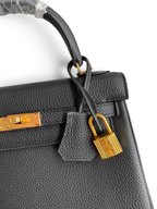 SWORD LUXURY Kelly 25 siyah Togo deri çanta, altın rengi kilit ve ikonik turn-lock kapama detaylı.
