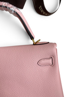 SWORD LUXURY Kelly 25 pembe Togo deri çanta, altın donanım detayları ve el işçiliği ile zarif bir tasarım.