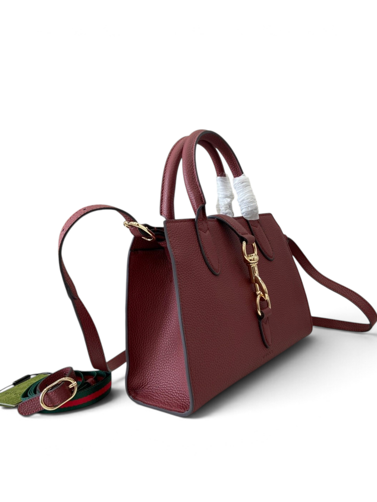 SWORD LUXURY Jackie mini tote çanta, bordo renkli dokulu vegan deri, altın tonlu toka ve çıkarılabilir omuz askılı.