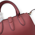 SWORD LUXURY Jackie mini tote çanta, dokulu bordo vegan deri, altın tonlu donanım ve üst taşıma sapı detayı.
