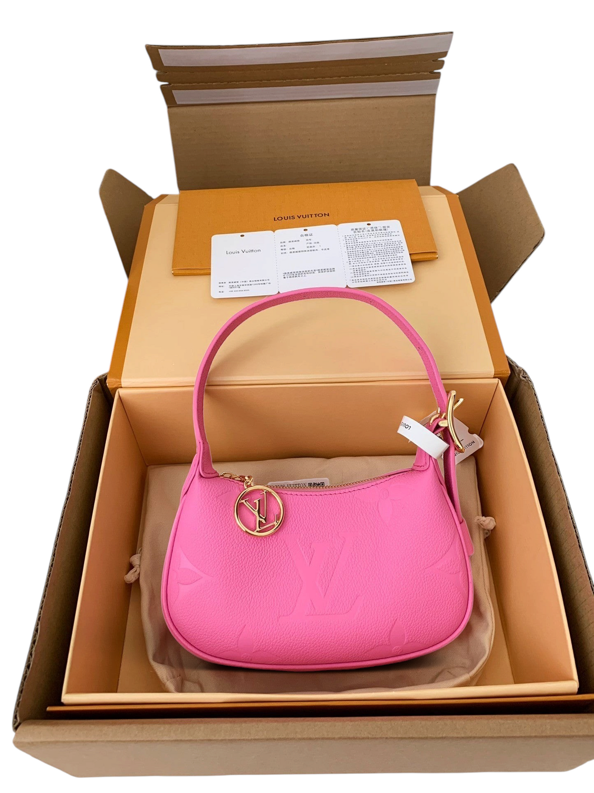 SWORD LUXURY pembe deri Mini Moon çanta, altın rengi LV charm detayı ve lüks kutu ambalajı ile birlikte.