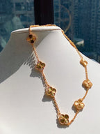 Gold necklace on a mannequin with a cityscape background