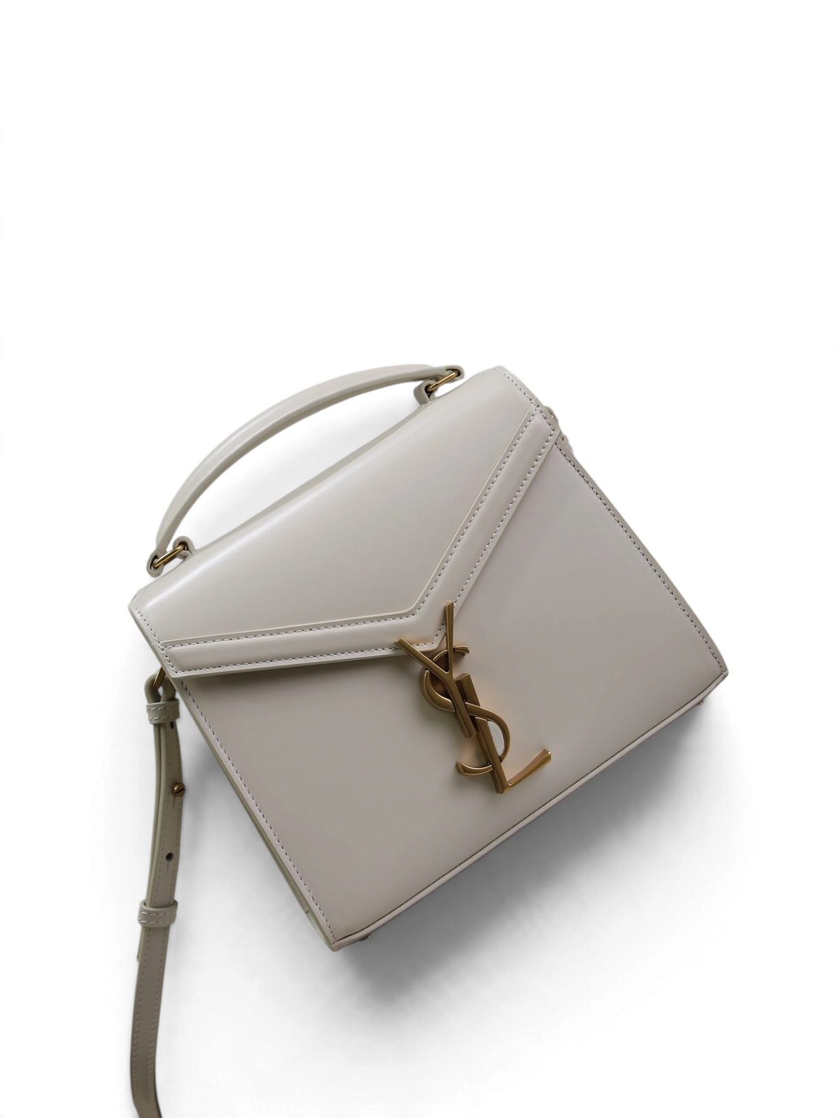 SWORD LUXURY Cassandra mini çanta, krem rengi pürüzsüz dana derisi, altın tonlu YSL monogram ve üst saplı tasarım.