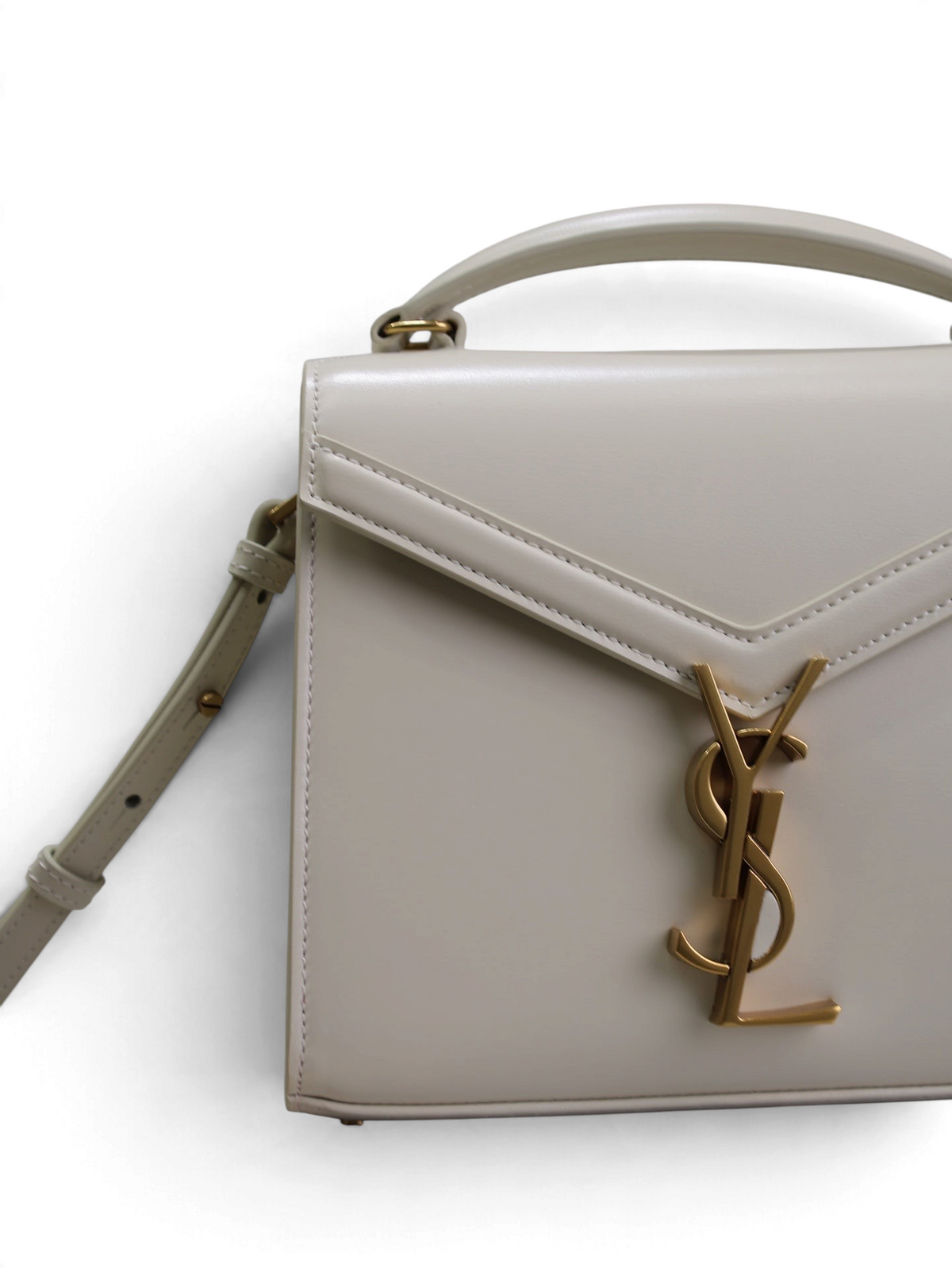 SWORD LUXURY Cassandra mini çanta, altın tonlu YSL logolu, krem rengi pürüzsüz deri, üstten saplı ve omuz askılı.