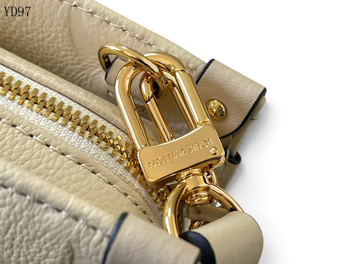 SWORD LUXURY Louis Vuitton OnTheGo East West çanta, altın tonlu metal zincir detayı ve kabartmalı deri dokusu.