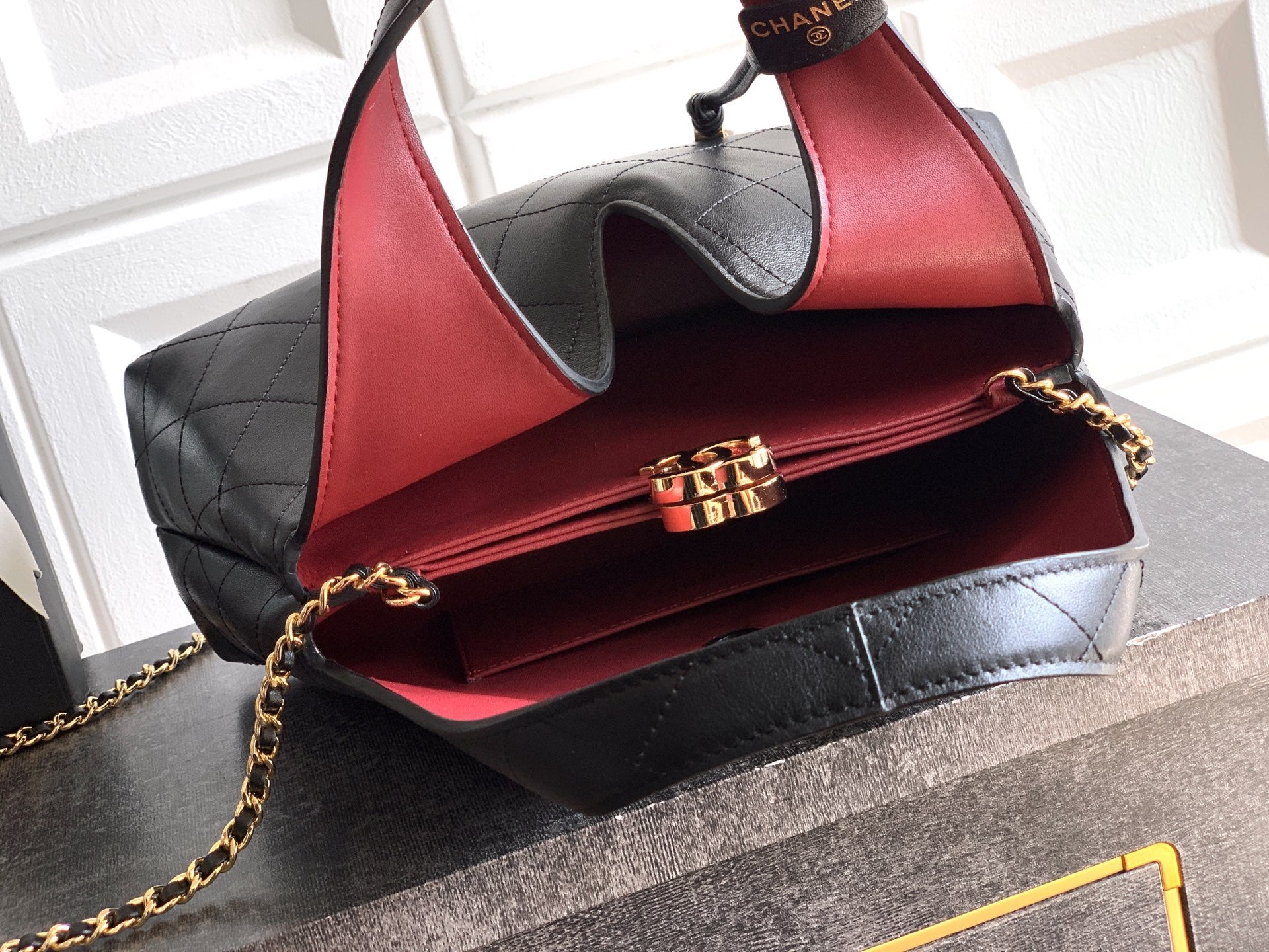 Quilted Leather Triangle Top Handle Bag