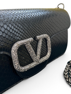 SWORD LUXURY Valentino Garavani VLogo siyah Ayers deri çanta, kristal süslemeli ikonik logo ve zincir askı detayıyla.