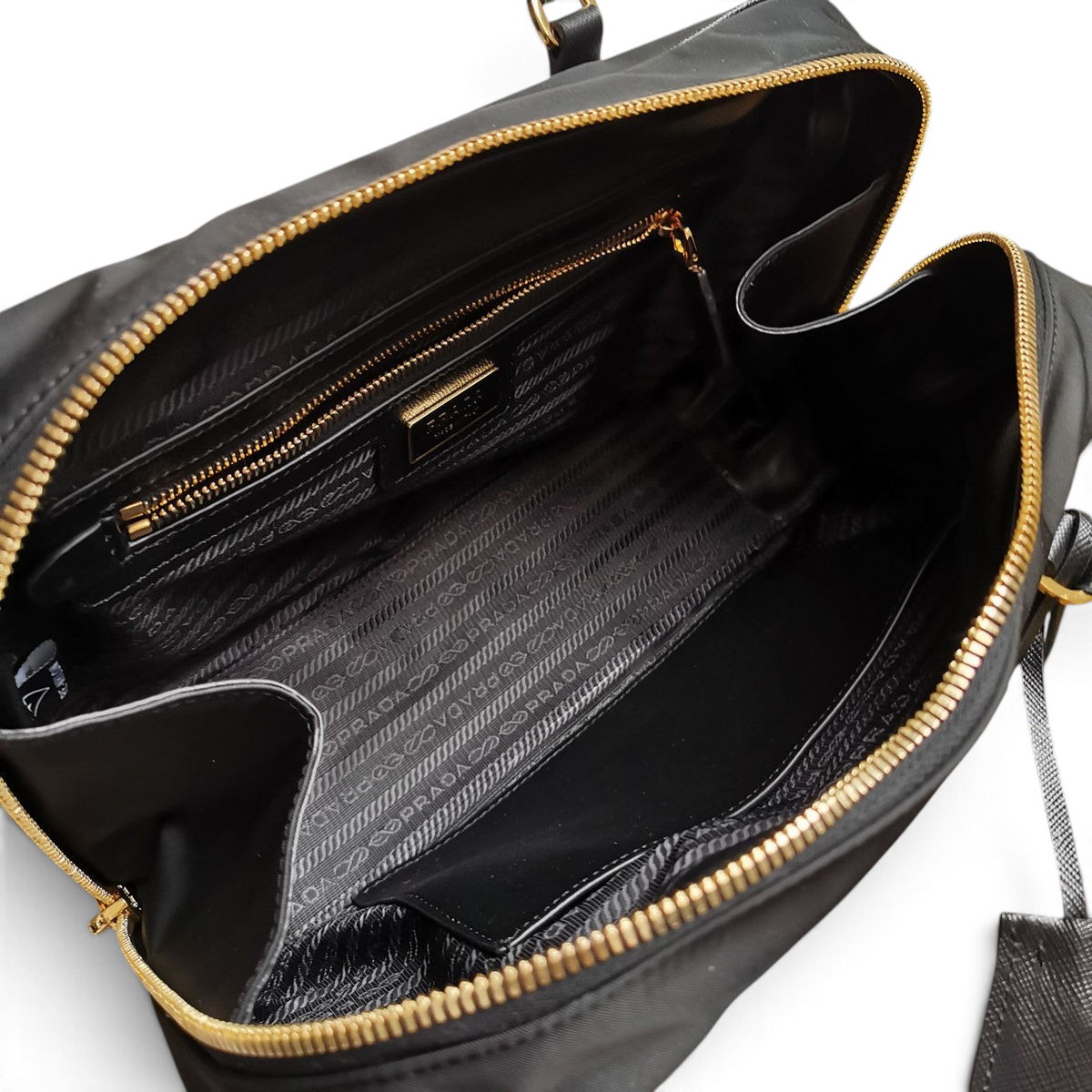 SWORD LUXURY Prada Re-Edition 1978 siyah Re-Nylon çanta, altın tonlu fermuar detaylı geniş iç bölme ve logolu astar.