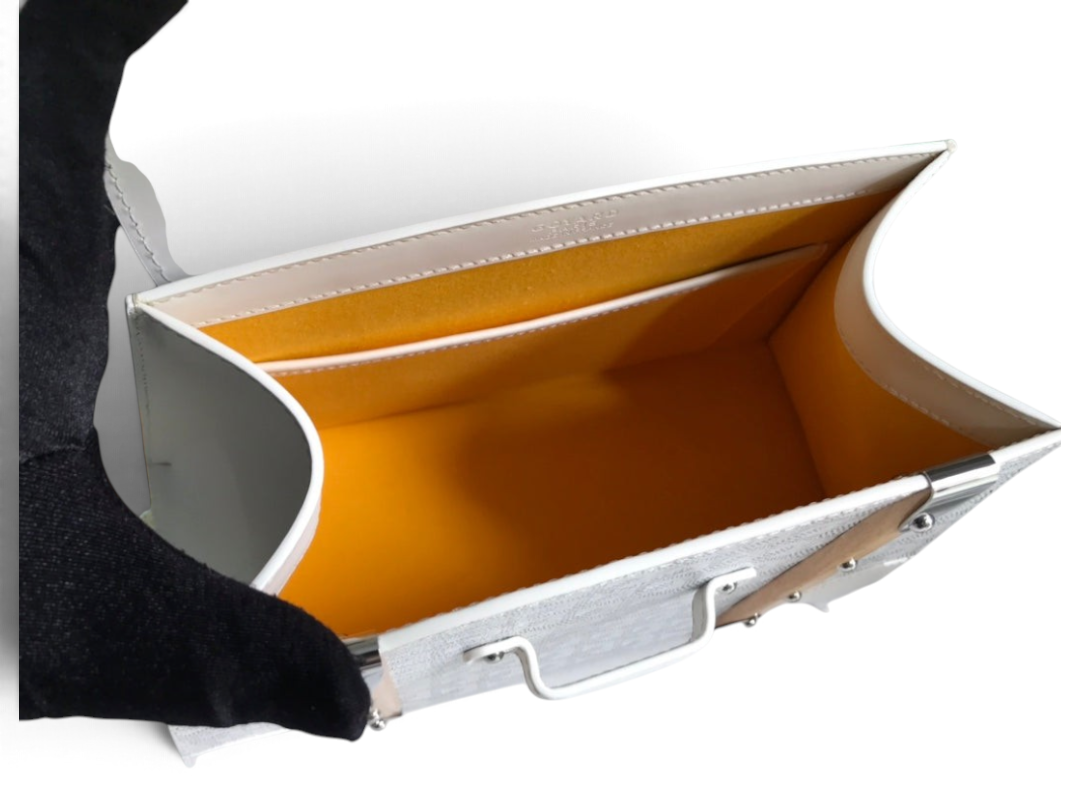 SWORD LUXURY Saïgon PM handbag interior featuring white Goyardine canvas, smooth leather trim, and vibrant yellow lining.