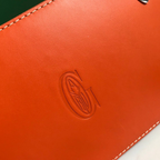 SWORD LUXURY Saïgon PM handbag featuring vibrant orange smooth leather with a debossed logo and white contrast stitching
