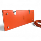 SWORD LUXURY orange leather base of the Saïgon PM handbag with silver protective feet and embossed logo detail.