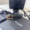 Black Saint Laurent belt with gold buckle on a branded box