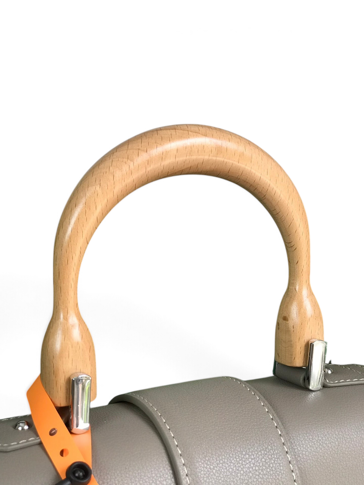 SWORD LUXURY Saïgon PM handbag featuring a smooth beechwood top handle and grey leather trim against a green box.