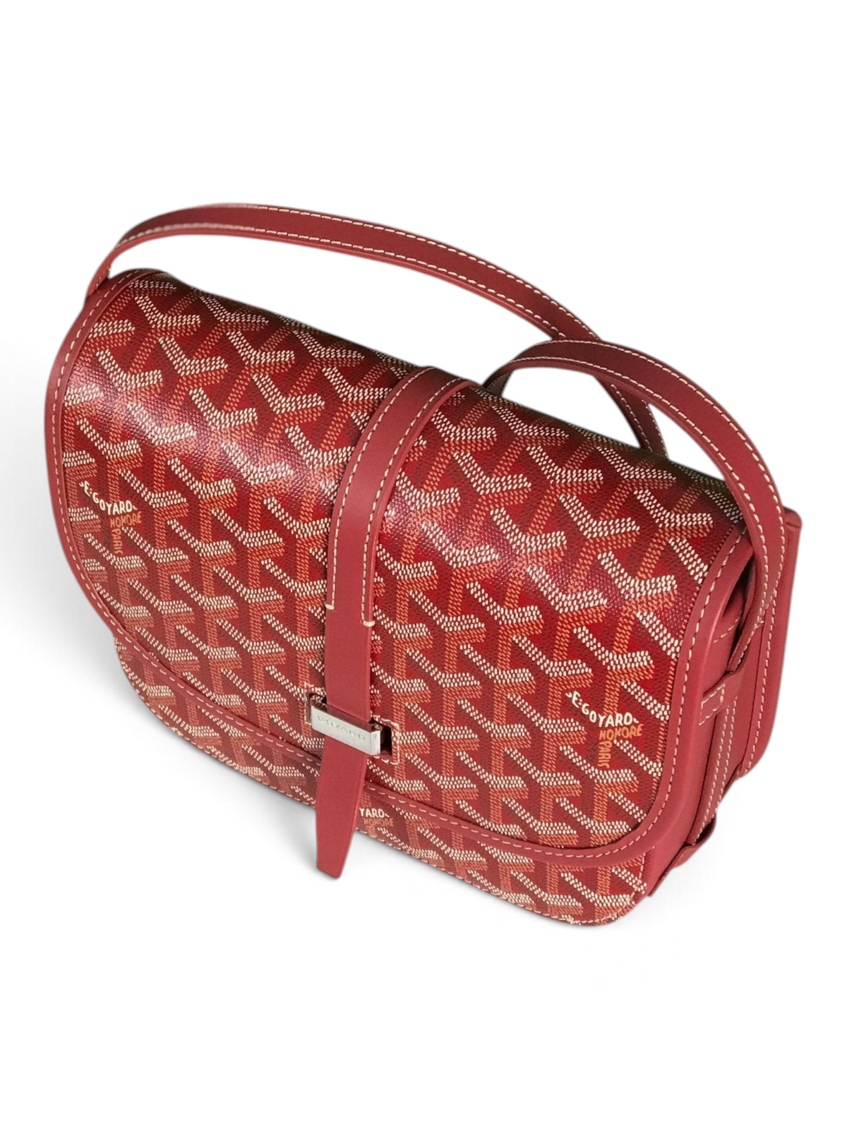 SWORD LUXURY Belvédère II messenger bag in red Goyardine canvas with leather trim and adjustable strap on a marble base.