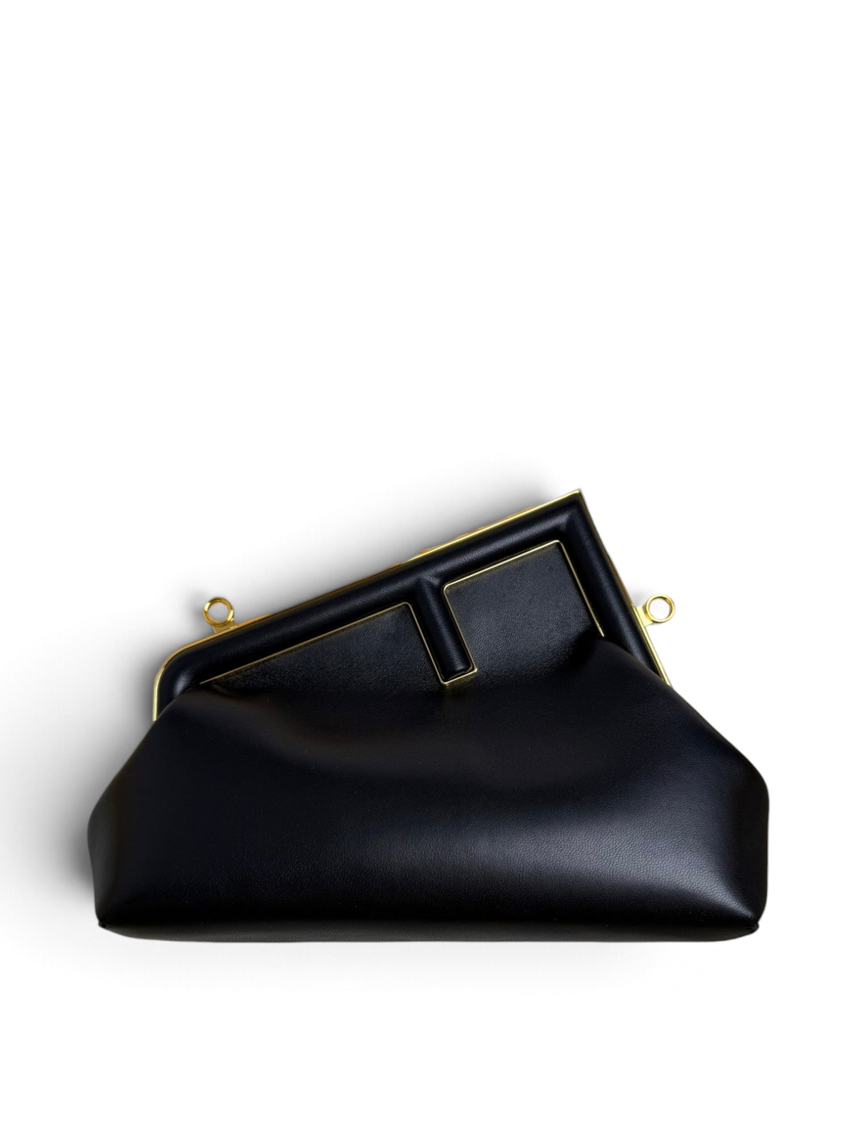 Black Fendi handbag in an open Fendi box on a white background