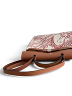 SWORD LUXURY Hermès Herbag 31 çanta, taba rengi deri detaylı ve sanatsal baskılı kanvas gövdeli şık tasarım.