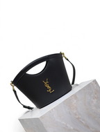 SWORD LUXURY siyah deri Cassandra mini çanta, altın renkli YSL monogram detaylı ve şık kesim saplı tasarım.