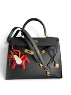 SWORD LUXURY siyah Epsom deri Hermès Kelly 32cm çanta, altın donanım, kilit ve at figürlü çanta süsü ile kutusunda.