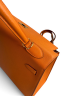 SWORD LUXURY turuncu Epsom deri Hermès Kelly 32cm çanta, altın rengi donanım ve ikonik dikiş detaylarıyla.