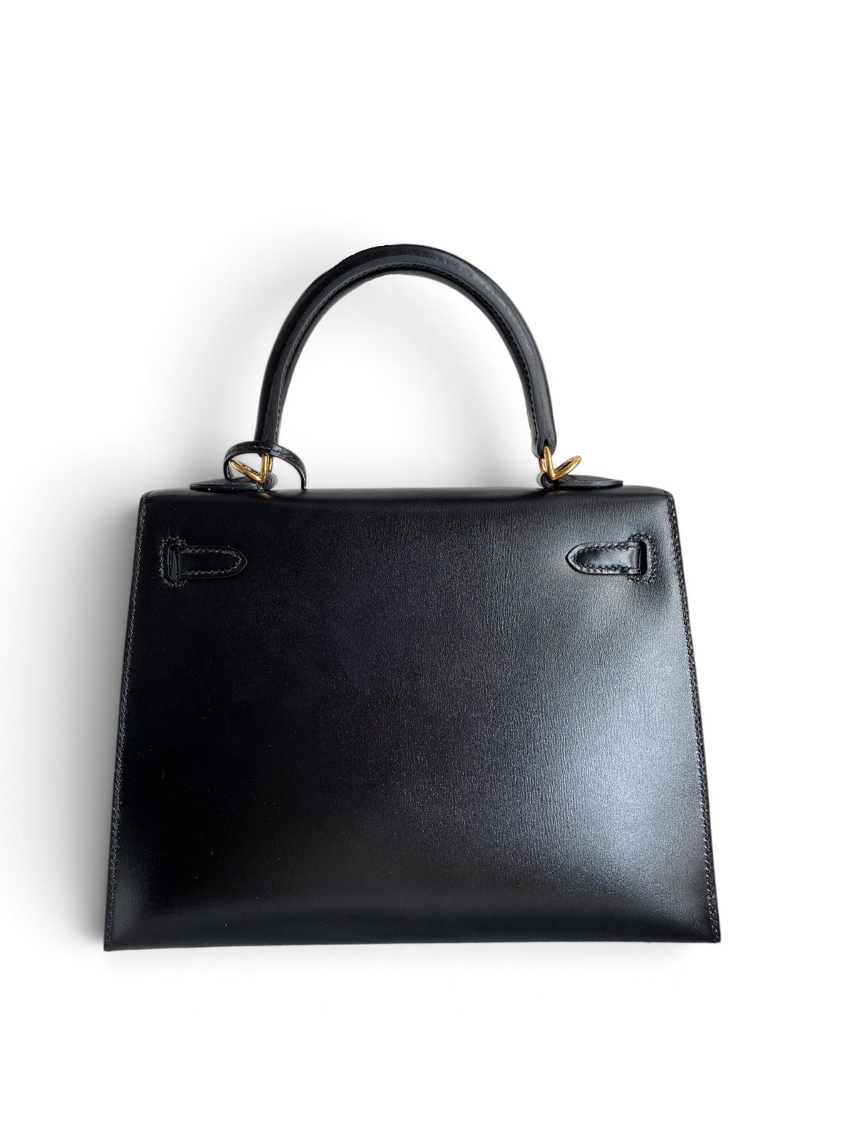 SWORD LUXURY marka siyah box deri Hermès Kelly 25cm çanta, kutusunda altın rengi donanımlı ve üst saplı tasarım.