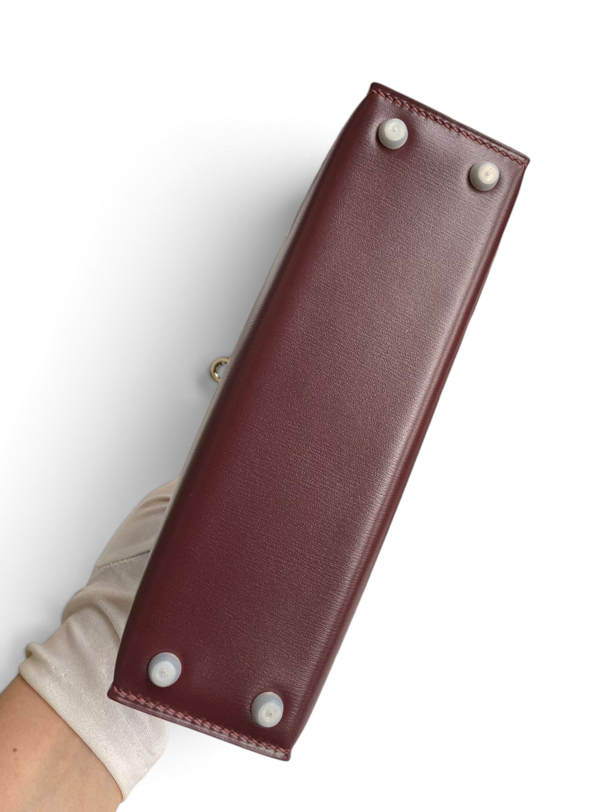 SWORD LUXURY Hermès Mini Kelly 19cm bordo box deri çanta, koruyucu taban çivileri ve detaylı alt görünümü.