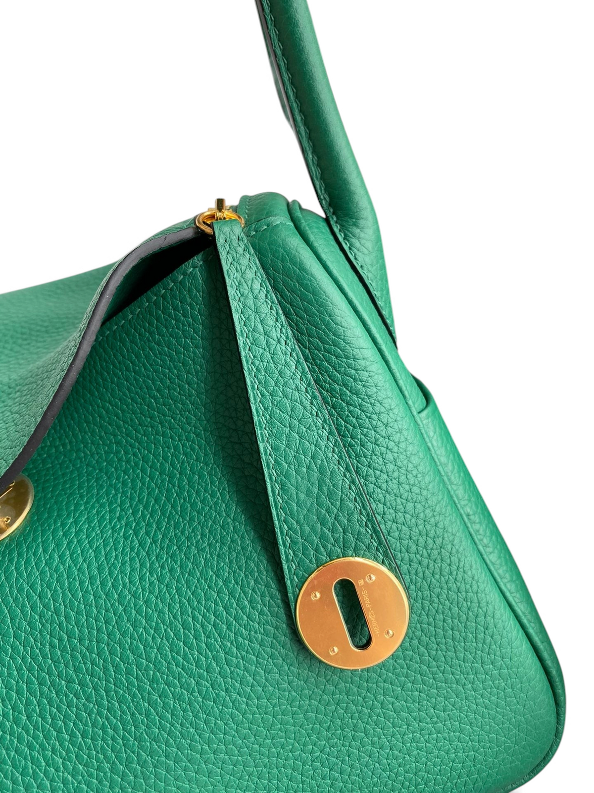 SWORD LUXURY Hermès Lindy 26 çanta, yeşil Clemence deri detayları ve altın rengi metal kilit mekanizması ile.