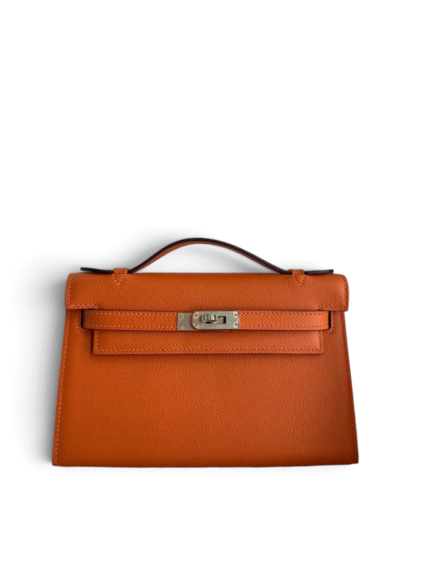 SWORD LUXURY turuncu Epsom deri 22 cm Mini Kelly çanta, kutu içerisinde, ikonik twist kilit detaylı.